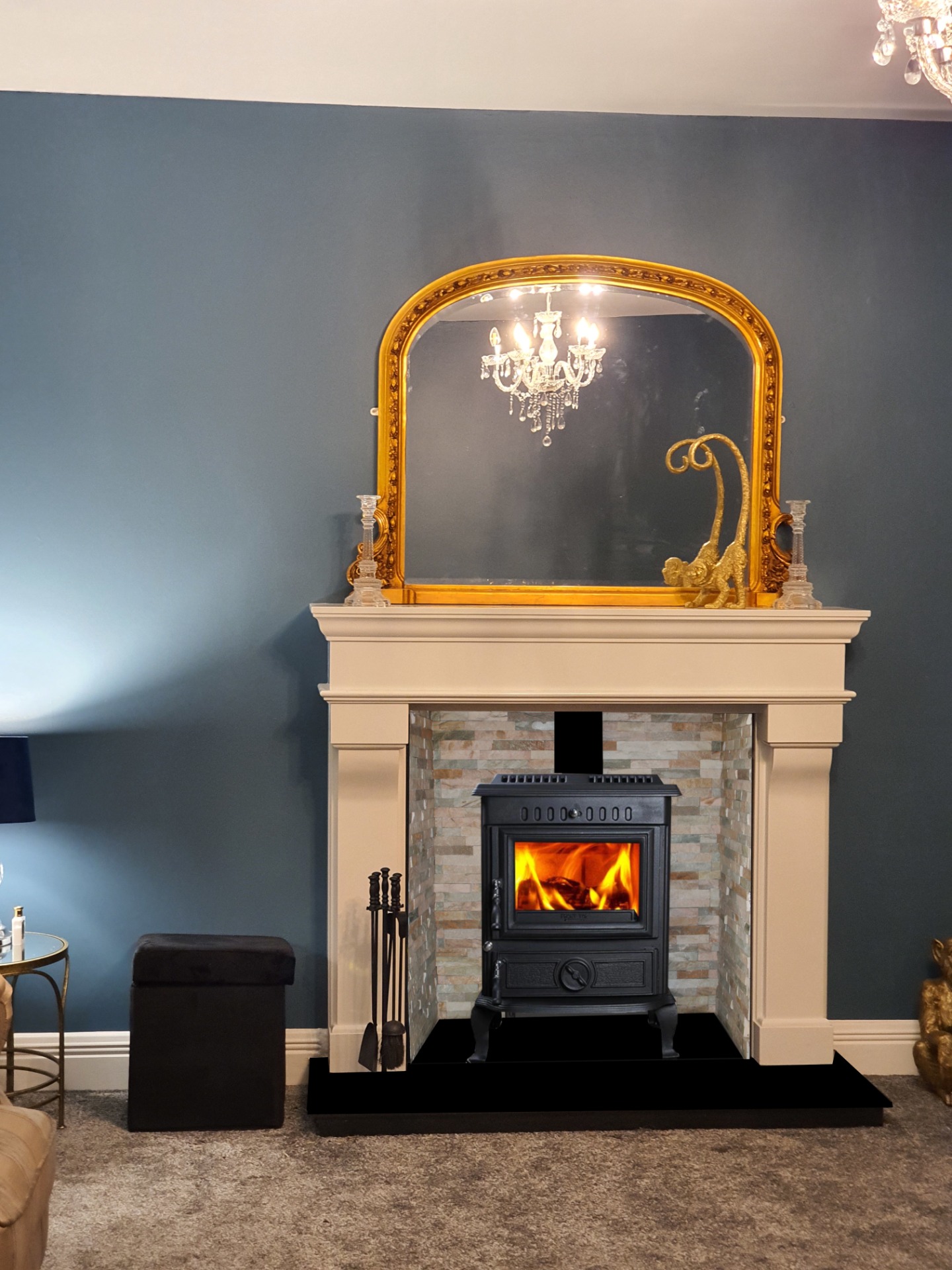 Aidan central heating stove fitted in a cream marble fireplace with the inside lined with an oyster natural stone tile. 